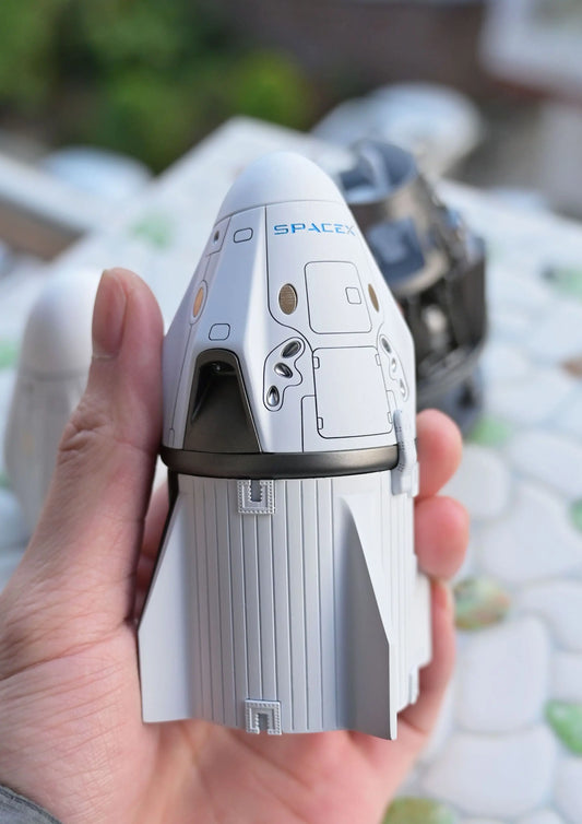 SpaceX Crew Dragon in 1/72 scale in a human hand