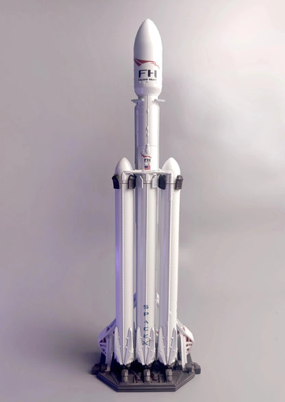 SpaceX Falcon Heavy on the desktop, front view, Falcon Heavy logo. Model in the scale of 1:200
