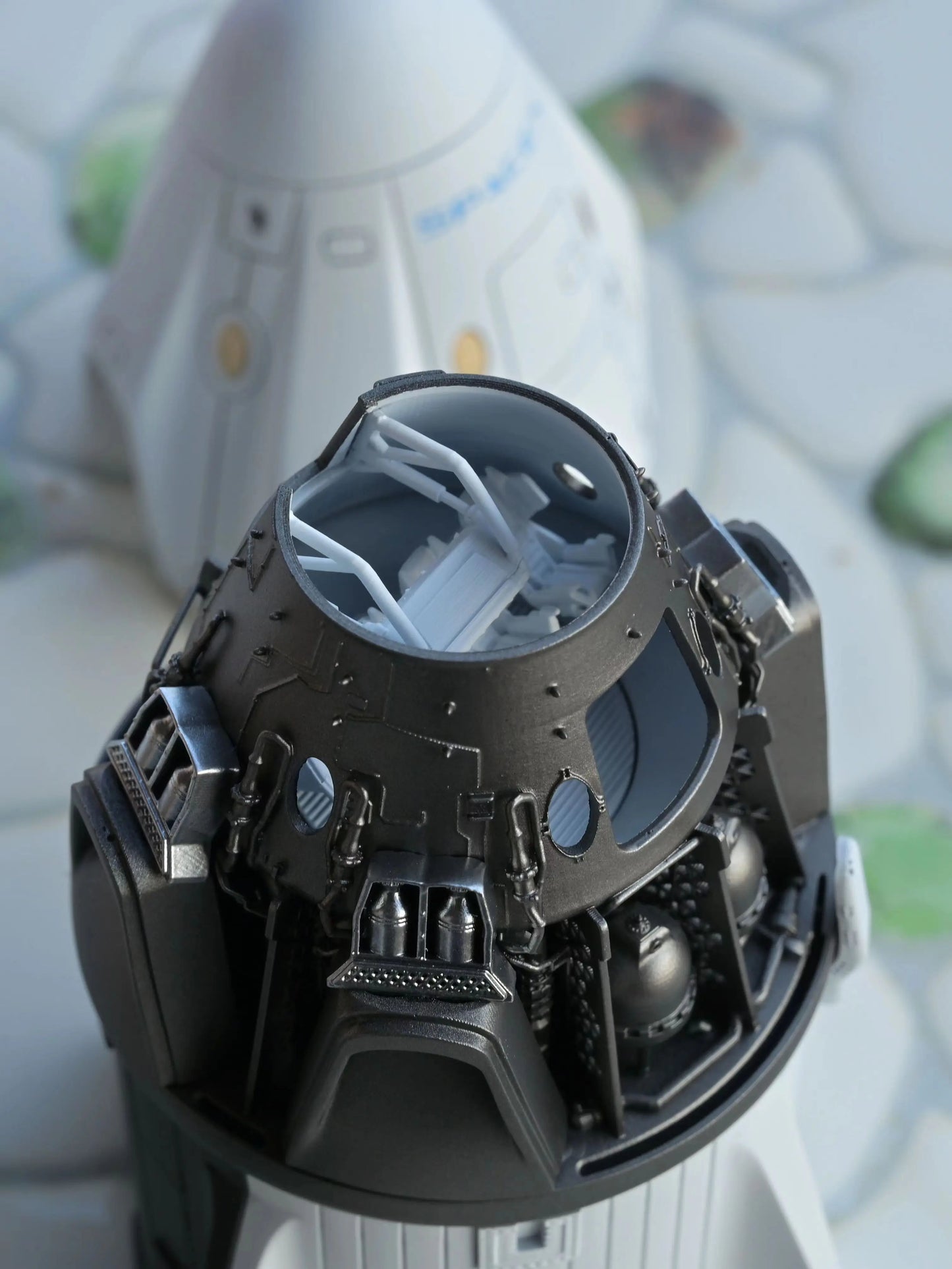 SpaceX Crew Dragon model showing details of the capsule interior and life support system under the skin