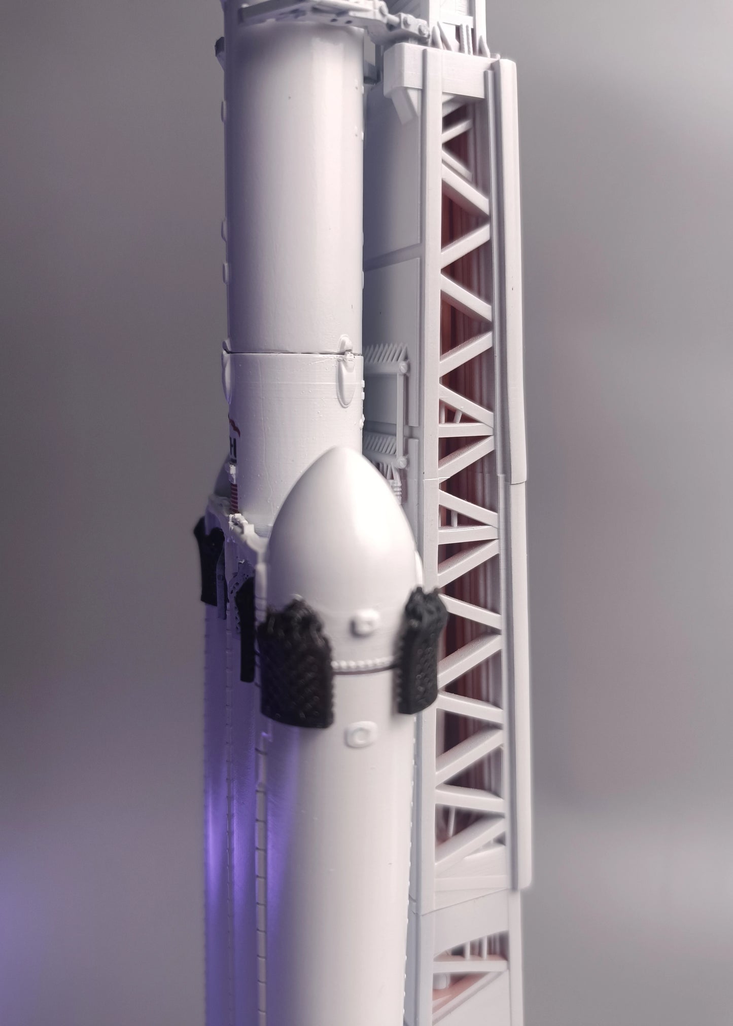 Grid rudders on the first stage of the Falcon Heavy rocket. SpaceX rocket model in 1:200 scale
