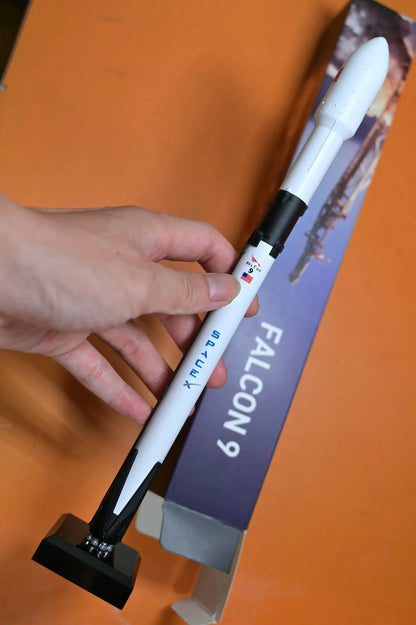 SpaceX Falcon 9 rocket model in hand